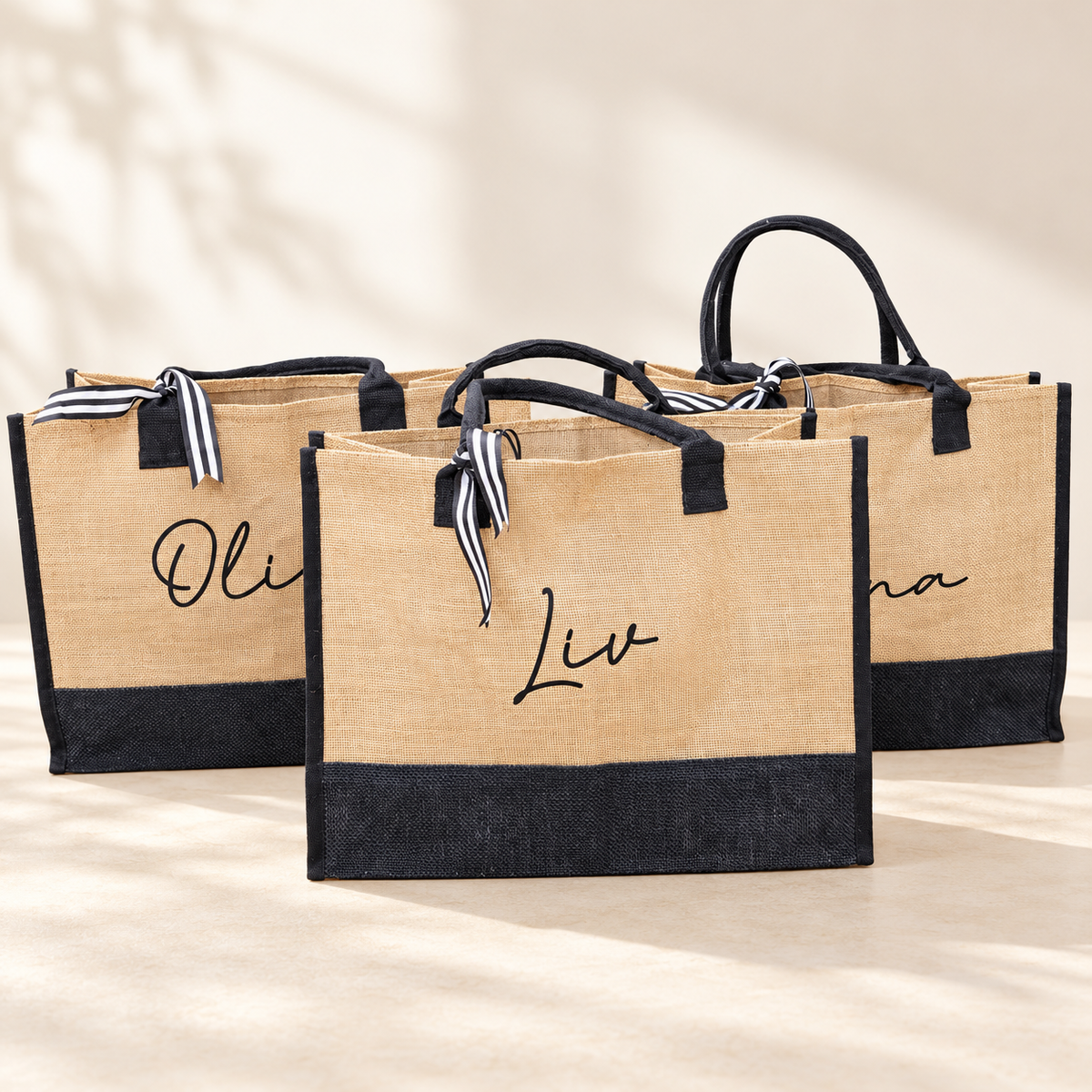 Personalized natural and black totes with ribbon accents and script names