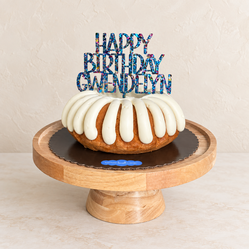 Personalized Happy Birthday Gwendelyn multicolor glitter acrylic cake topper on a white birthday cake