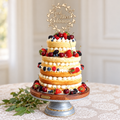 Personalized God Bless wood cake topper displayed on a baptism or First Communion cake