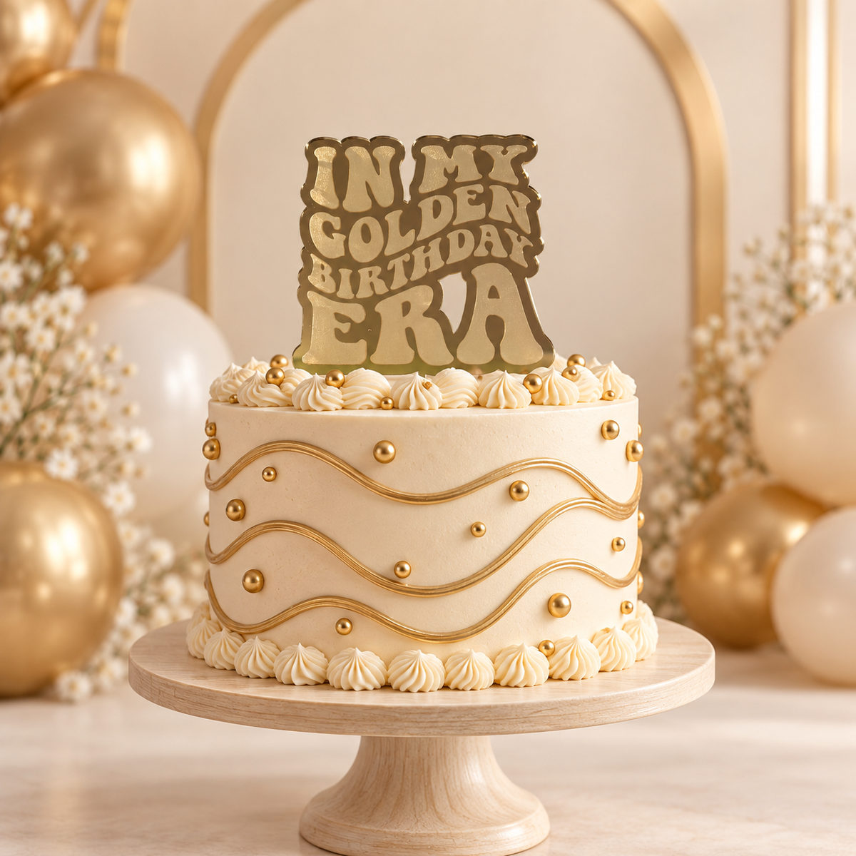 In My Golden Birthday Era gold mirrored acrylic cake topper displayed on an ivory and gold birthday cake