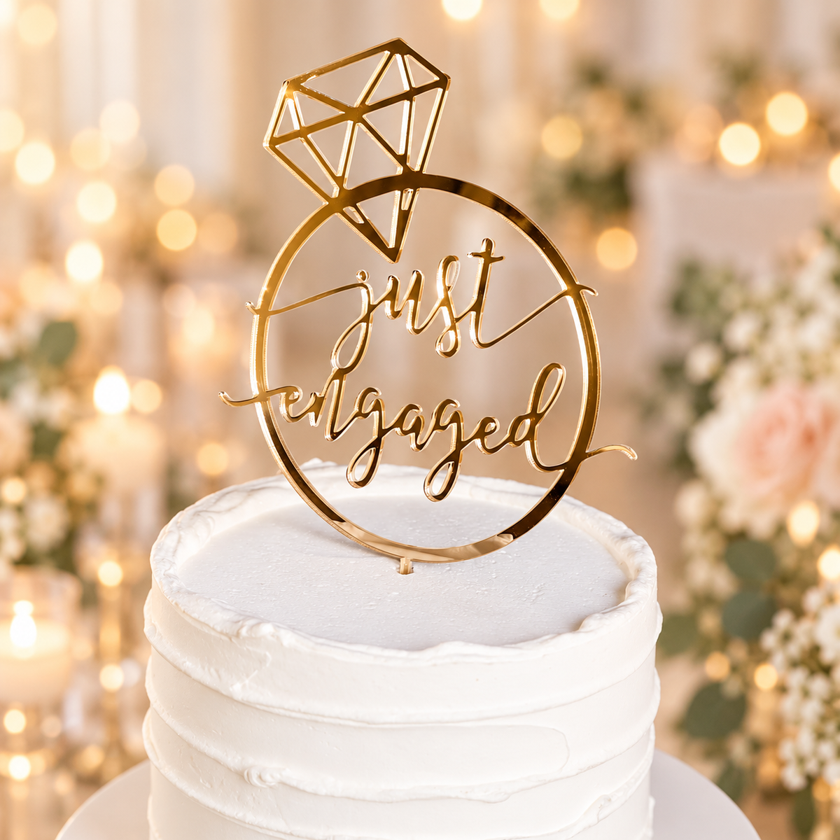 Close-up of gold acrylic Just Engaged cake topper with diamond ring design