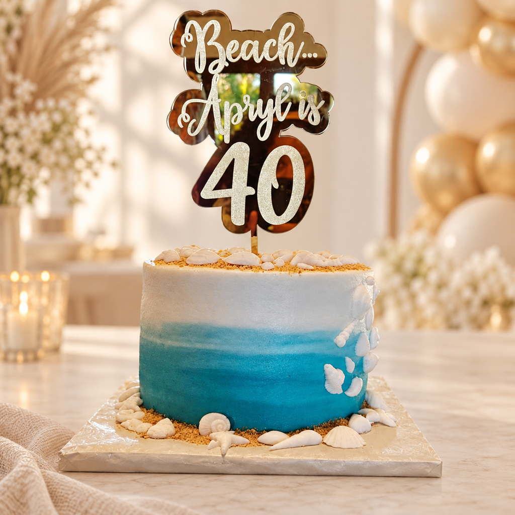 Gold mirrored custom saying topper on a beach-themed 40th birthday cake