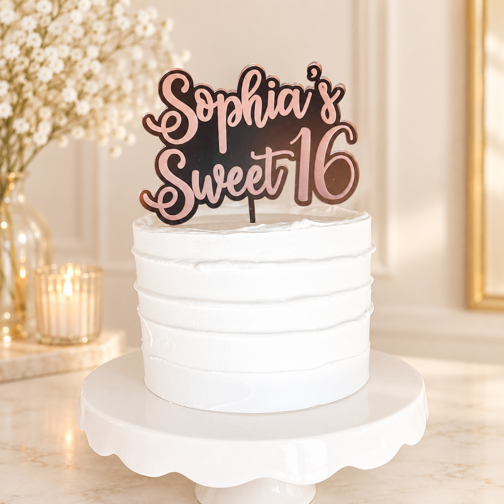 Rose gold personalized Sweet 16 acrylic topper on a white cake