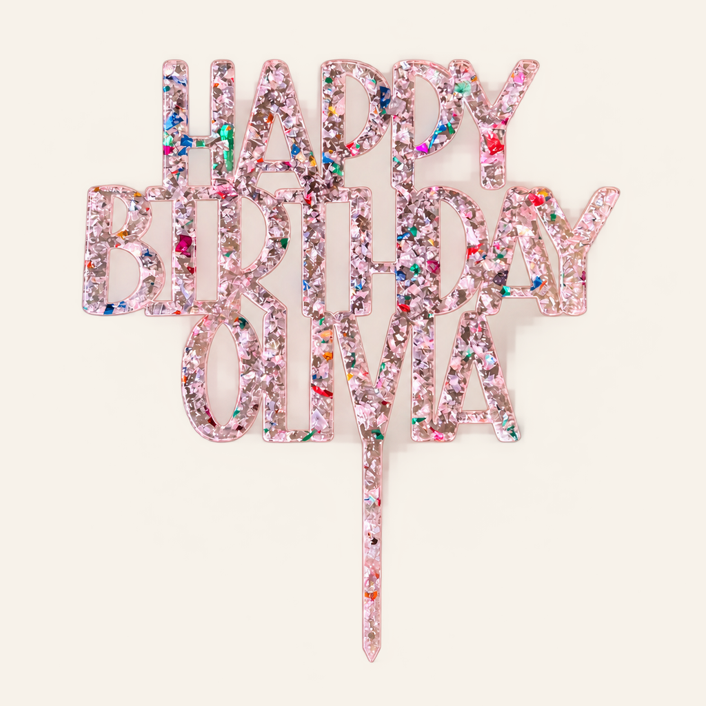 Personalized Happy Birthday Olivia pink glitter-flake acrylic cake topper on a cream background