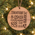 Personalized wooden baby birth stats ornament hanging on a Christmas tree
