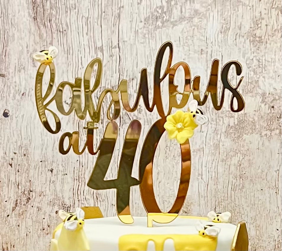 Close-up of Fabulous at 40 gold mirror acrylic cake topper