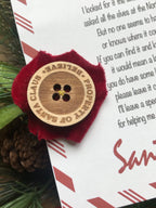 Santa’s lost button with letter